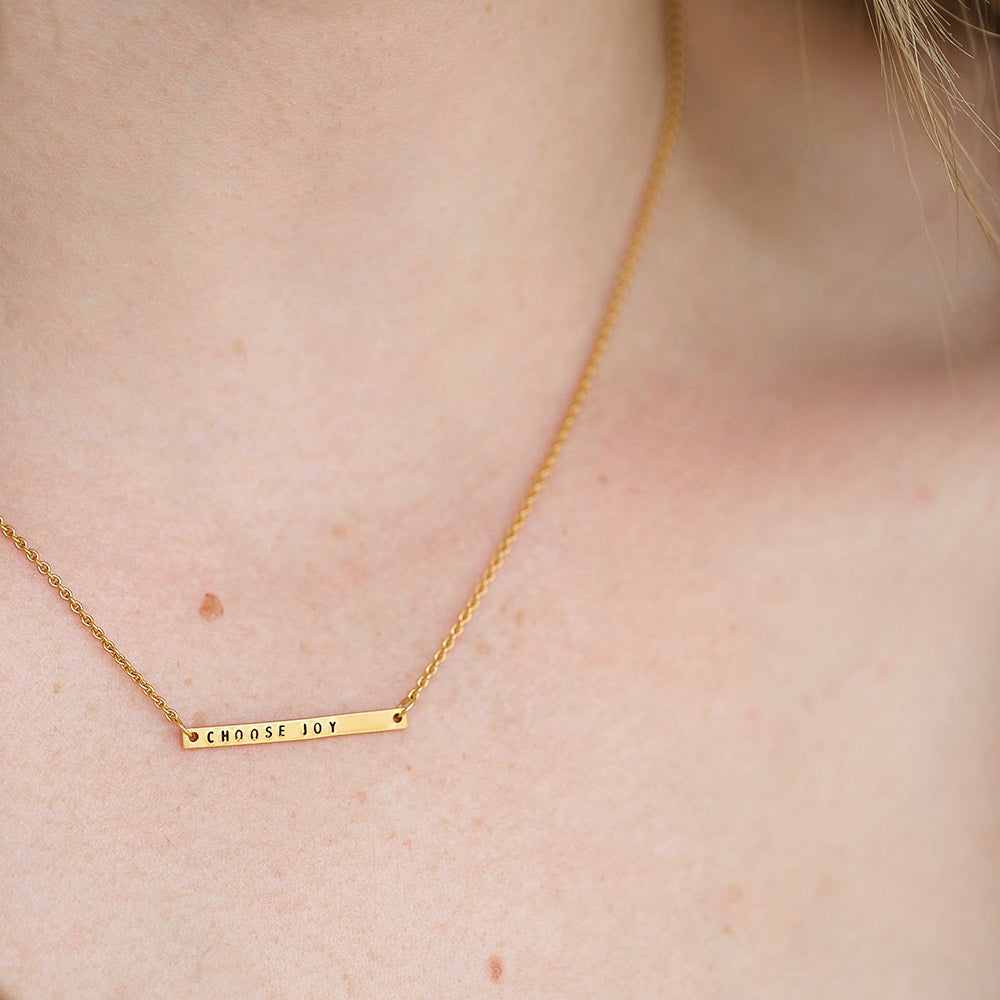 gold bar necklace on model