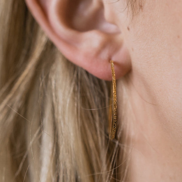 gold diamond dusted hoops on model | christina kober