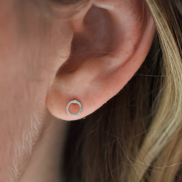 silver karma studs on model