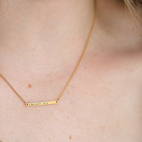 gold bar necklace on model