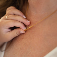 gold bar necklace on model