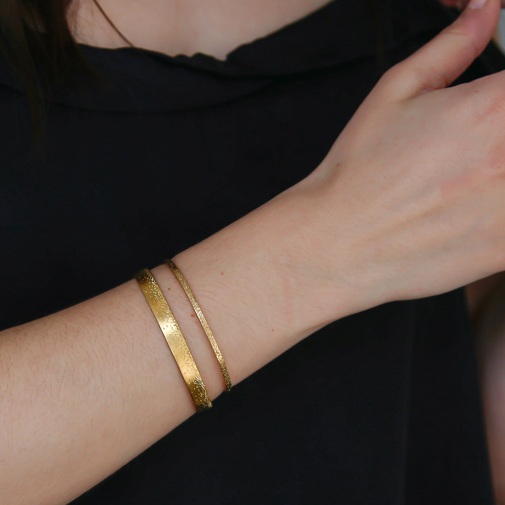 gold diamond dusted grand cuff and narrow cuff on model