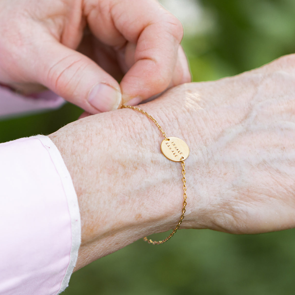 gold mini coin bracelet on model