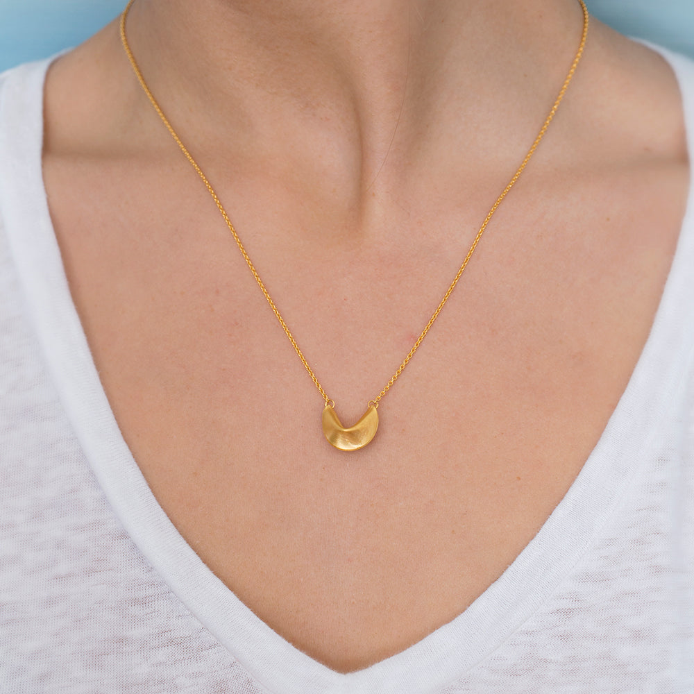 gold fortune cookie necklace on model
