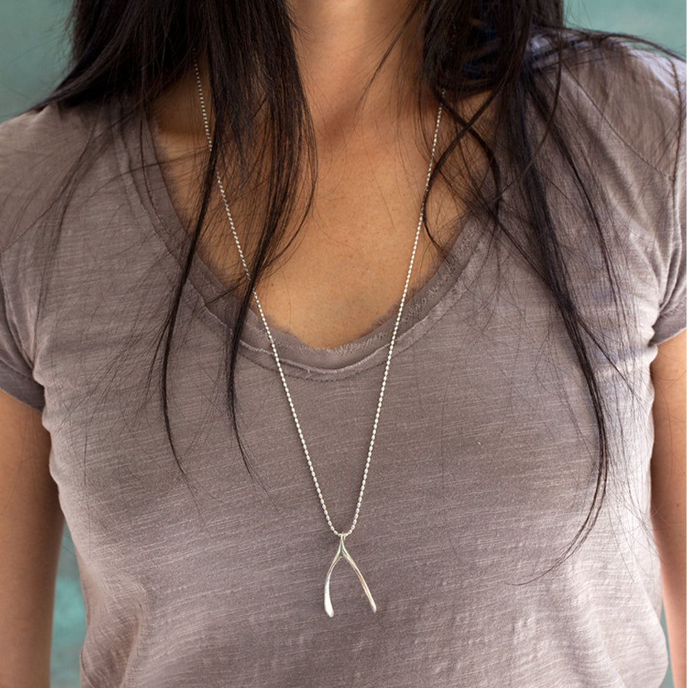 silver large wishbone necklace on model
