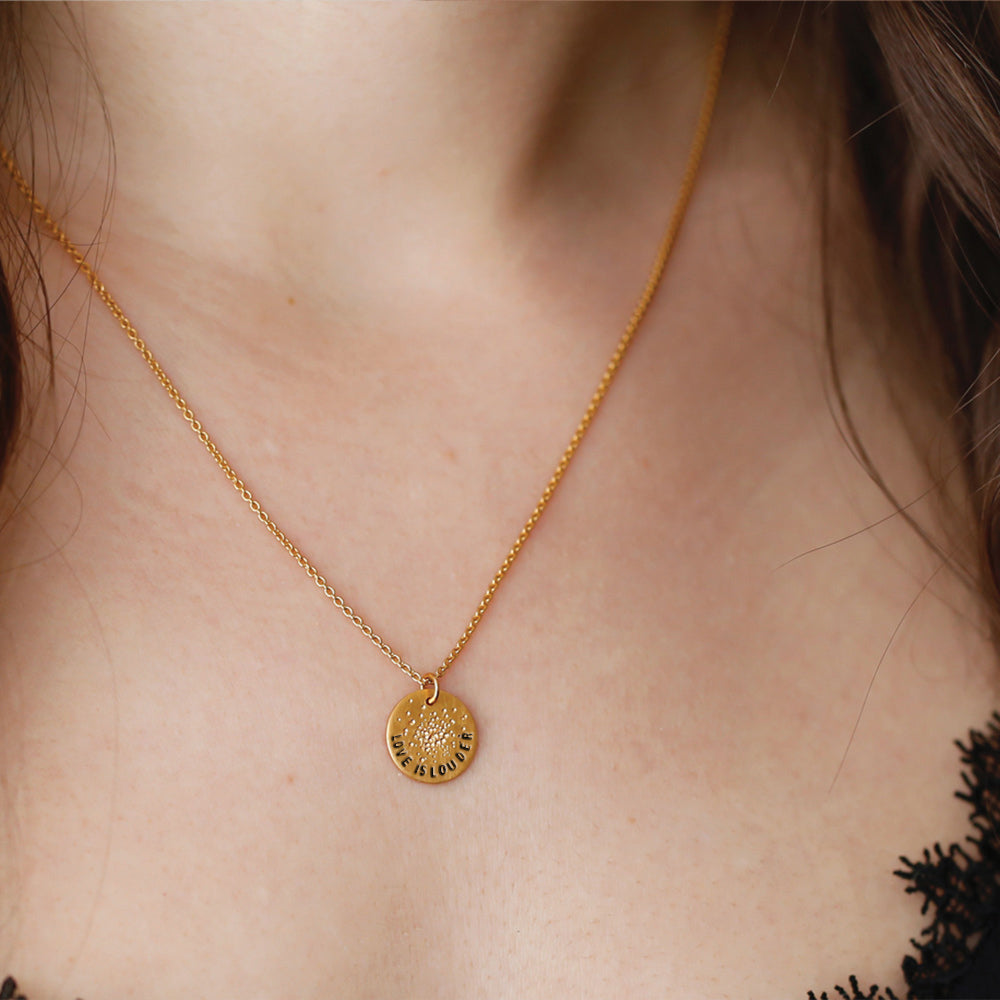 love is louder gold mini coin necklace on model