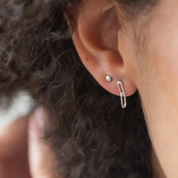 silver linked earrings on model